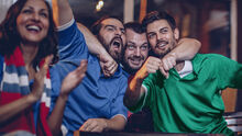 a group of British & Irish Lions fans watching a game