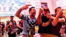 three men in origin jerseys cheering
